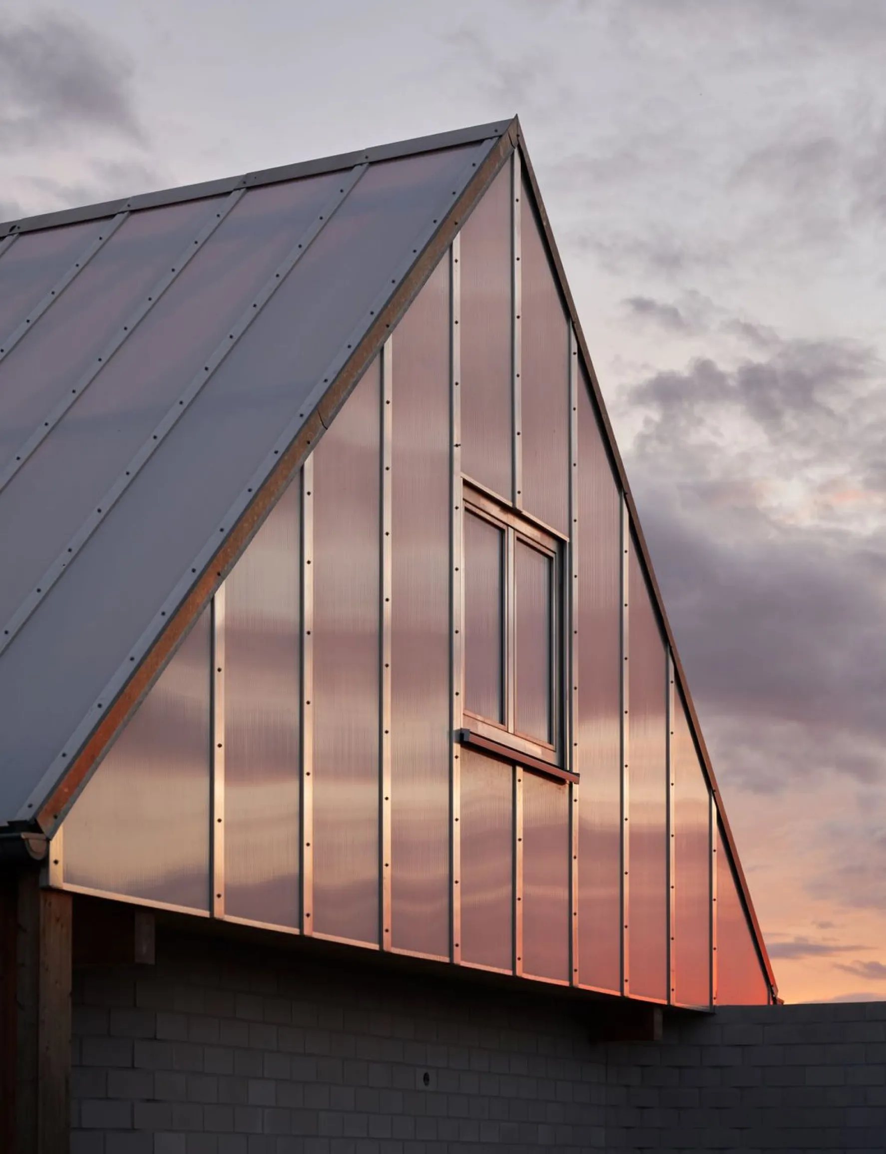 Modern building with triangular copper roof
